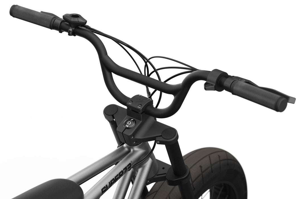 Studio image showing the handlebars and branded stem cap on the SUPER73-ZX in Metallic Aluminum. @color_metallic aluminum