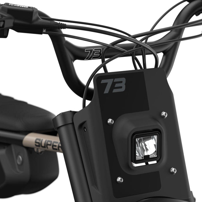 Detail image of the handlebars and headlight on the SUPER73-Z Adventure Core ebike in Sandstorm. @color_sandstorm