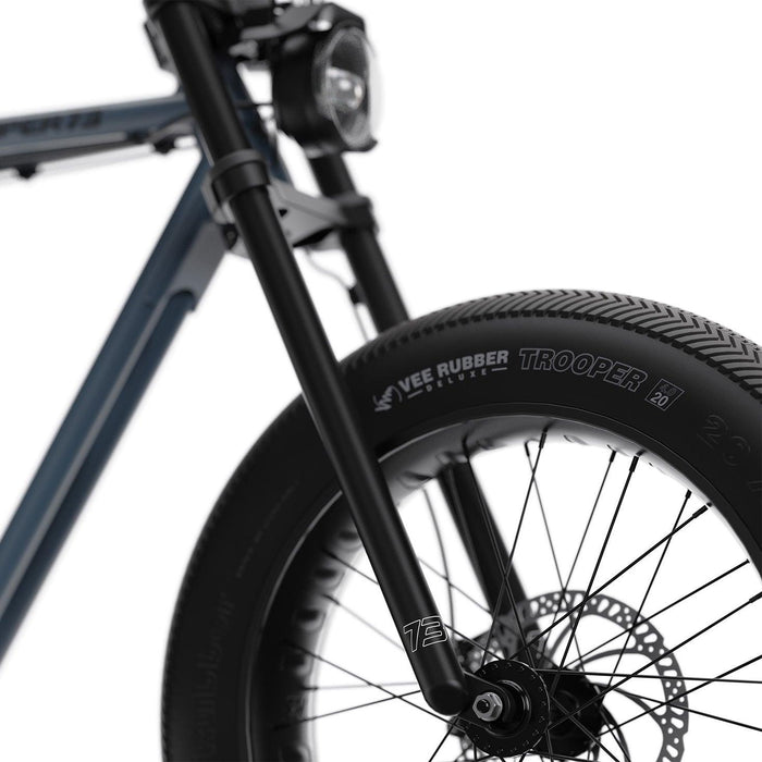 Detail image showing the front fork and TROOPER tires on the SUPER73-ZX ebike in Panthro Blue. @color_panthro blue