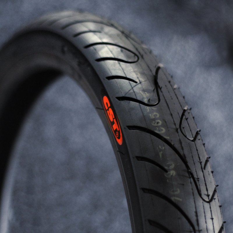 Close-up of a tire with a brand logo on a dark background