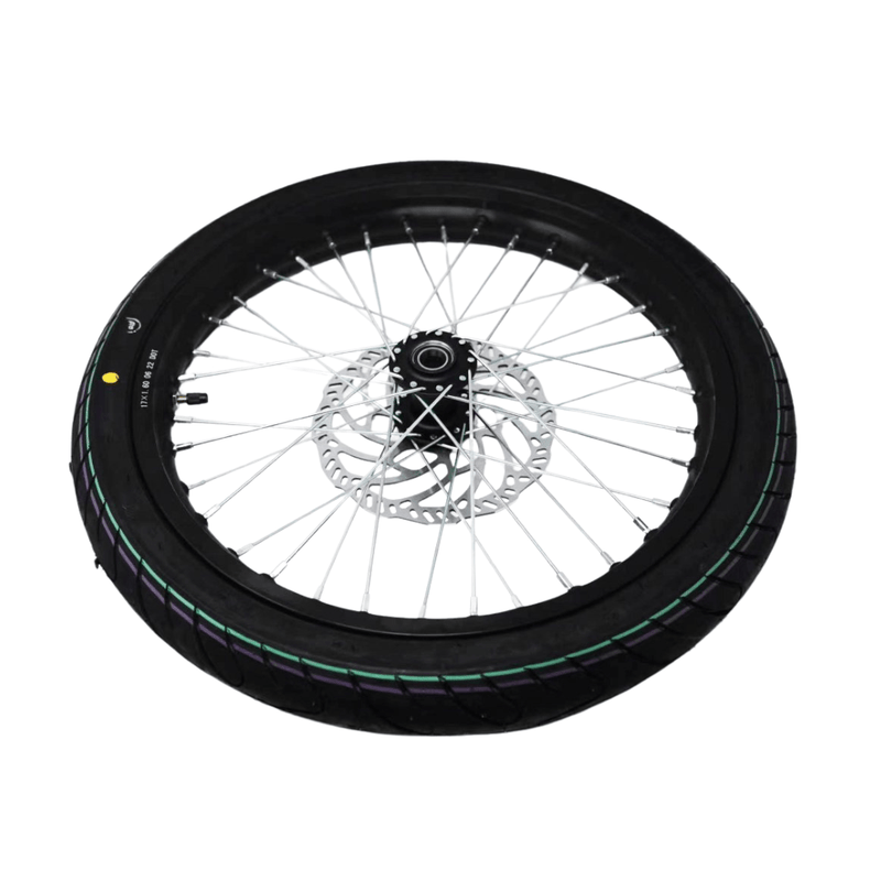 Motorcycle wheel with black tire and silver rim on a white background