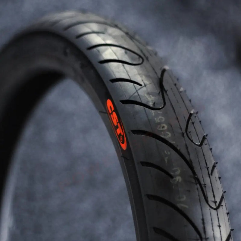 Close-up of a tire with a brand logo on a dark background